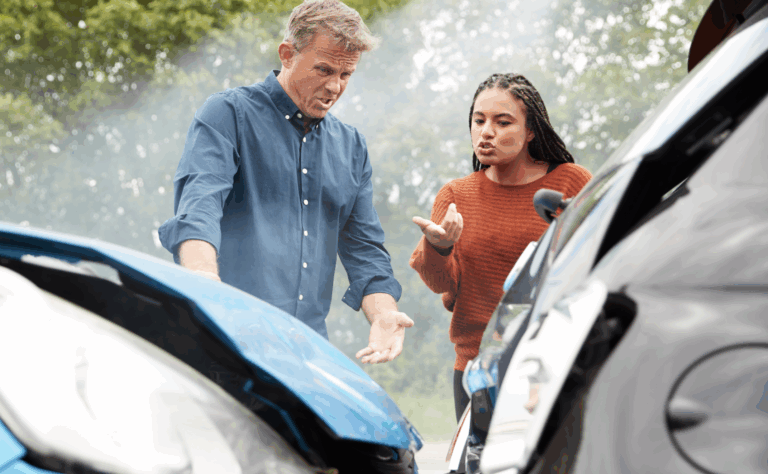 A man and woman arguing in front of the scene of a car accident trying to figure out fault | Daniel Stark Law